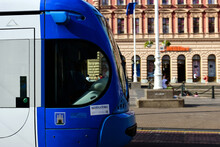Extreme Closeup Of Blue Tram In The Popular Jelacic Square In Downtown Zagreb. Old Architectural Background. Tourism And Travel To Croatia Concept. Urban Area. Blurred Urban Background With Tourists 