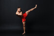 © primipil - Sportsman muay thai man boxer stance at black background.