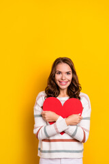 Wall Mural - Vertical closeup photo of young attractive smiling happy lady hold red paper heart gift love boyfriend isolated on yellow color background