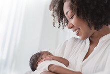 Close Up Portrait Of Beautiful Young African American  Mother Holding Sleep Newborn Baby In Hospital. Healthcare Medical Love Black Afro Woman Lifestyle Mother's Day, Breast Concept With Copy Space.