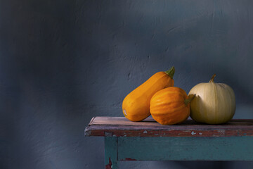 Wall Mural - orange pumpkins on old wooden table on background green wall