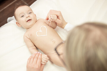 female masseur doing baby massage for foot little infant baby child