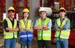 © atitaph - A team of Asian male and female factory workers stand with confidence and success. in industrial plants
