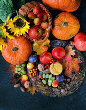 Wiccan Altar For Mabon Sabbat. Wheel Of The Year With Amulet, Fruits, Pumpkins, Flowers On Black Table. Witchcraft, Esoteric Spiritual Ritual. Autumn Equinox Holiday. Top View