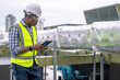 © Basicdog - Engineer checking the cooling system of the factory air conditioner.