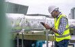 © Basicdog - Engineer checking the cooling system of the factory air conditioner.