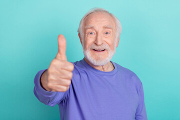 Sticker - Photo of satisfied cheerful aged man arm finger demonstrate thumb up rate quality isolated on teal color background