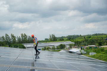 Wall Mural - Engineer man or worker checking the operation of the system solar panels or solar cells on roof,Renewable energy source,Eco technology for electric power.