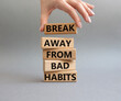 Break away from bad habits symbol. Wooden blocks with words Break away from bad habits. Beautiful grey background. Businessman hand. Business and Break away from bad habits concept. Copy space.
