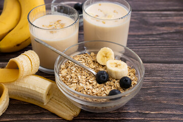 Wall Mural - Banana, oatmeal, milk on a wooden background