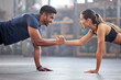 © Alexis Scholtz/peopleimages.com - Support, teamwork and fitness couple doing workout training, challenging exercise for endurance, strength and stamina in a gym. Active, fit man and woman giving support and motivation during pushup