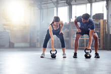 Fitness Couple Doing A Kettlebell Workout, Exercise Or Warmup Training In A Gym. Fit Sports People, Woman And Man With A Strong Grip, Exercising Using Equipment To Build Muscles And Forearm Strength.