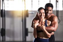 Strong, Active And Wellness Couple Looking Fit And Healthy After Workout Training Session In A Gym. Young Sexy, Attractive And Athletic Boyfriend And Girlfriend Hugging After Reaching Fitness Goal