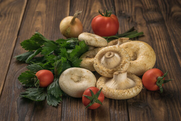 Wall Mural - Fresh milk mushrooms, tomatoes and a bunch of parsley on a wooden background.