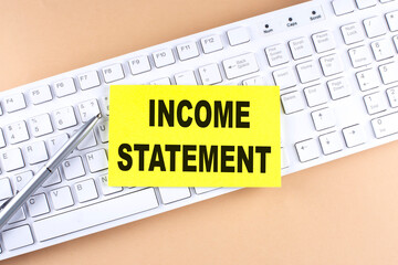 Poster - INCOME STATEMENT text on a sticky on keyboard, business concept