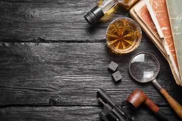 Wall Mural - Whiskey in the drinking glass on the detective desk table background concept. Top view.