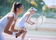 © Michael Cunningham/peopleimages.com - Female tennis player or sports woman with racket and sports gear playing a match outdoors sport court. Fit young girl enjoying hobby, exercising or competitive activity with equipment or sporty gear