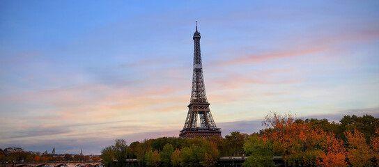 Wall Mural - Eiffel Tower, iconic Paris landmark  as autumn trees park across the River Seine with tourist boat in sunset sky scene at Paris ,France