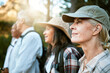 © Courtney Haas/peopleimages.com - . Hiking, adventure and exploring with a group of senior friends enjoying a walk or nature hike in the forest or woods outdoors. Closeup of mature retired people on a journey for outside discovery.