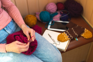 Wall Mural - woman is knitting, female hands close-up