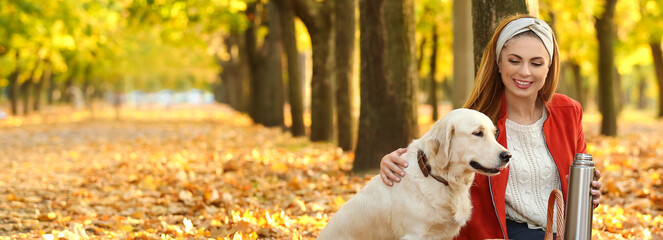 Canvas Print - Happy woman with her cute dog in autumn park