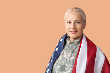 Wall Mural - Mature female soldier with USA flag on beige background