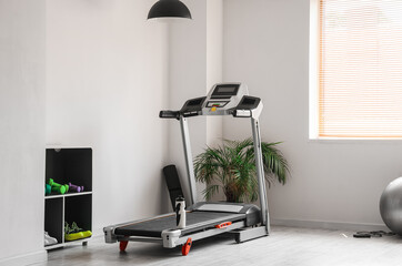 Poster - Modern treadmill with bottle of water in gym