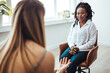 Psychologist listening to her patient and writing down notes, mental health and counseling concept. Shot of an attractive young woman sitting and talking to her psychologist during a consultation