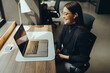 © Jacob Lund - Young businesswoman having a virtual meeting in a coworking office