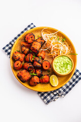 Wall Mural - Tandoori Soya Chaap or soy chap dish prepared by marinating in tandoori spices, closeup view