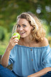 © auremar - portrait young charming blonde woman biting green apple