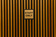 staff only text on a steel board on a door.
