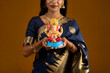 © Dip Photography - Happy young Indian woman posing with Ganesha statue on the occasion of Ganesh Festival