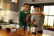 © Wavebreak Media - Happy biracial lgbt male couple preparing healthy drink together in kitchen
