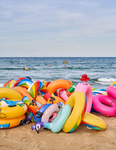 My Khey Beach, Danang Vietnam, A Vendor Offers Inflatable Beach Toys At A Beach.