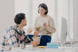 © VK Studio - Photo of lovely woman and man discuss working issues together while have lunch, eat fast food and fresh vegetable salad, pose at desktop with computer monitor and scientific literature. Teamwork