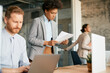 © Drazen - Black female CEO analyses reports while working at corporate office.