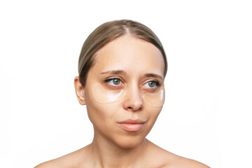 Sticker - Portrait of a young caucasian woman with gel colorless transparent patches on the skin under her eyes isolated on a white background. Skin care, cosmetology concept