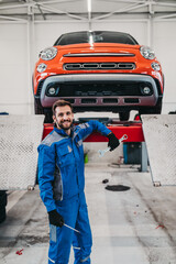 A professional mechanic working in a car service.