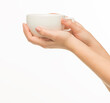 © serhii - female hands hold a white cup on a white background isolated