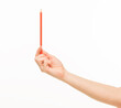 © serhii - female hands holding orange pencil on white background isolated