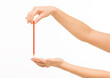 © serhii - female hands holding orange pencil on white background isolated
