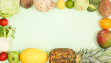 Creative Frame With Fresh Ripe Fruits And Vegetables On Bright Green Background. Flat Lay