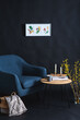 © Syda Productions - interior and home decor concept - close up of blue chair, coffee table and blanket in basket in dark room