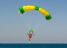Old Man Landing His Parachute On Barra Da Tijuca Beach In Rio De Janeiro