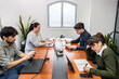 © Valeria Venezia - People working on laptops during a meeting in the office