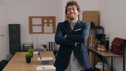 Poster - Young hispanic man business worker standing with arms crossed gesture at office