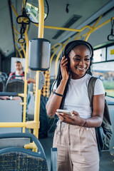 Poster - African american woman using smartphone while riding a bus