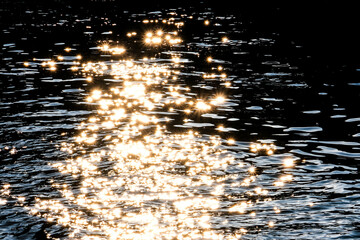 Wall Mural - sunlight glitters on river water surface