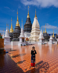 Asian traveller women wearing traditional clothes at beautiful Wat Ban Den Temple is a famous place and travel destination attraction in Mae Tang district Chiang Mai, Northern Thailand. Religion worsh